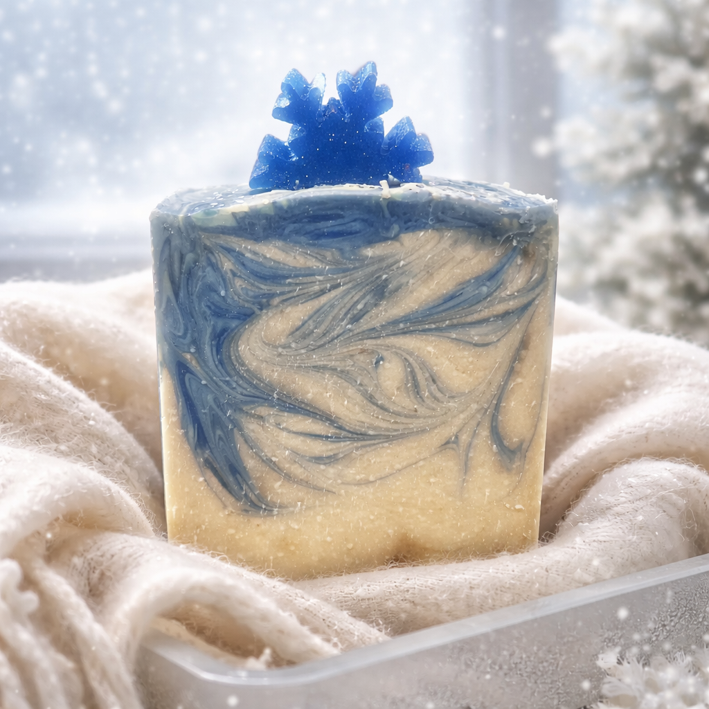 White soap with a blue swirl with a blue snowflake on top. 
